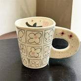 Splashing ink, hand pinching ceramic coffee cup