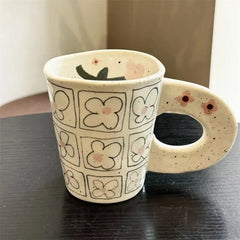 Splashing ink, hand pinching ceramic coffee cup