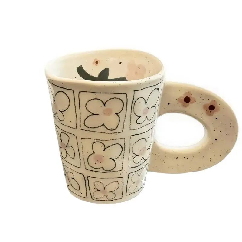 Splashing ink, hand pinching ceramic coffee cup