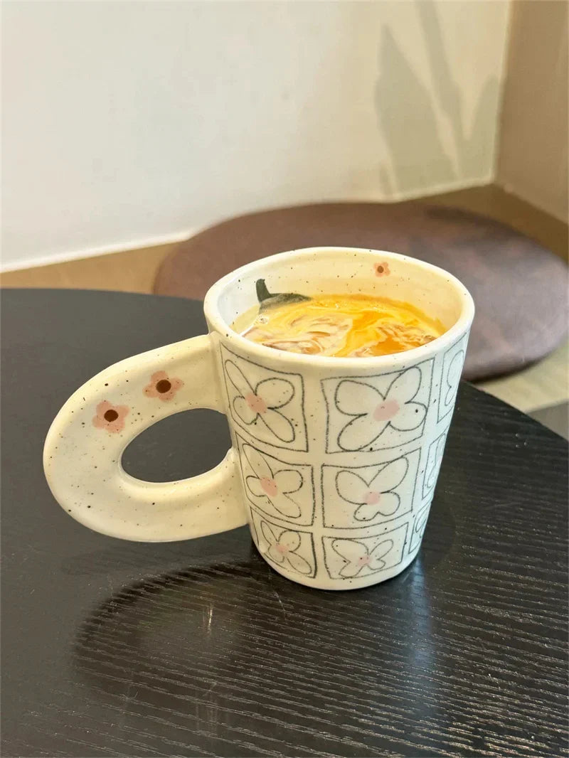 Splashing ink, hand pinching ceramic coffee cup